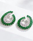 Aretes Queens Candy estilo vintage con zirconias cúbicas verdes y blancas en forma de media luna sobre base plateada.