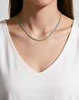 Queens Candy silver-toned tennis necklace featuring round-cut light blue cubic zirconia stones on a model