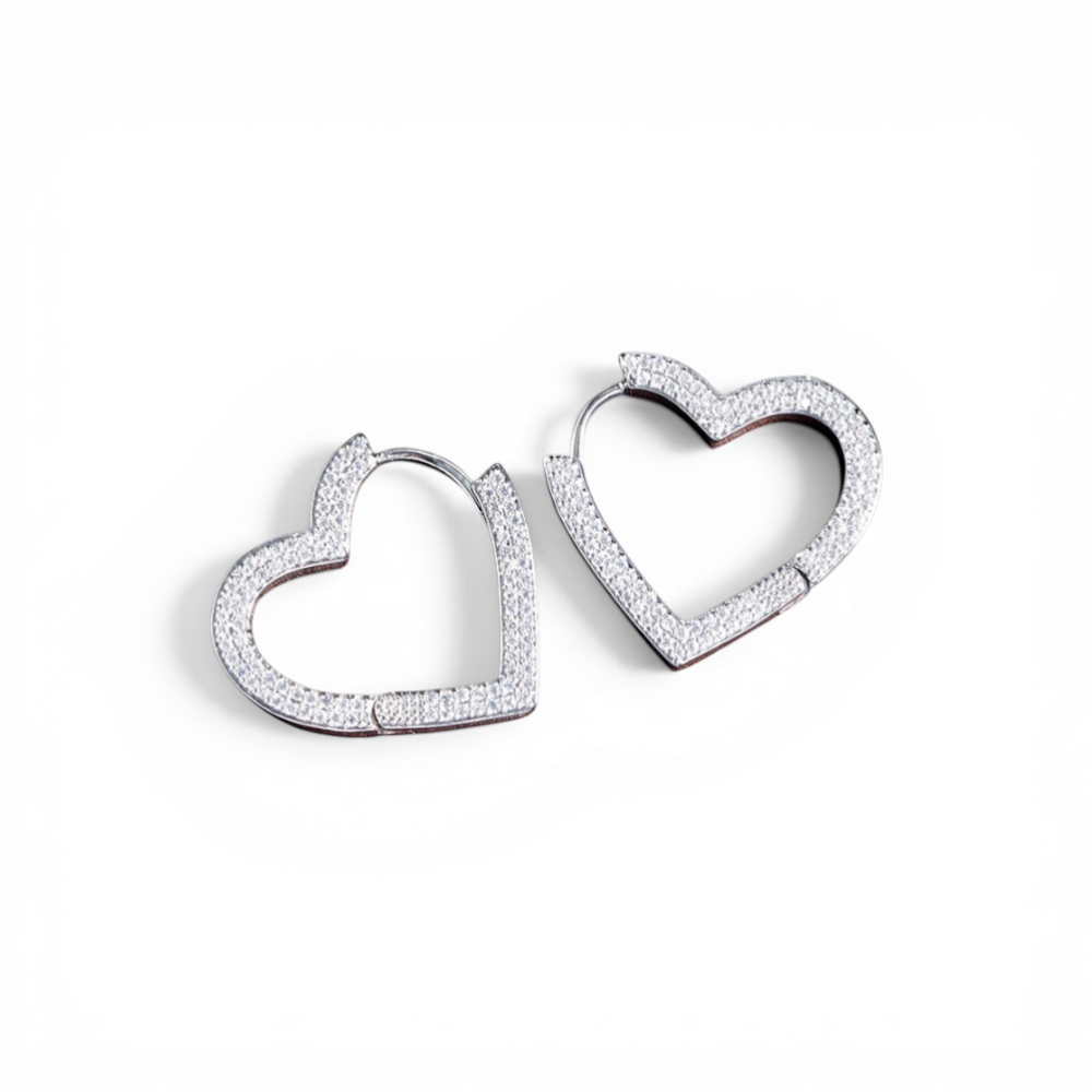 Queens Candy silver plated copper heart hoop earrings with cubic zirconia pave detail.