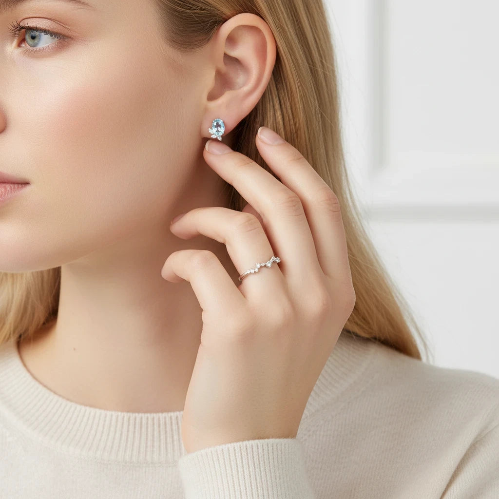 Queens Candy gold-plated sterling silver stud earrings featuring an oval aquamarine and marquise cubic zirconia.