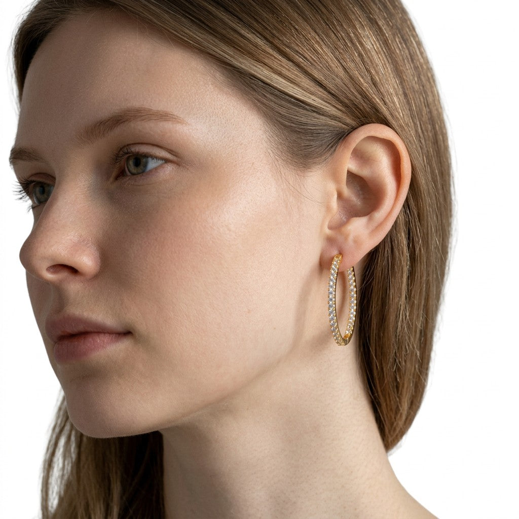 Aretes hoop Queens Candy de 26mm en cobre con baño dorado y zirconias brillantes puestos en una modelo
