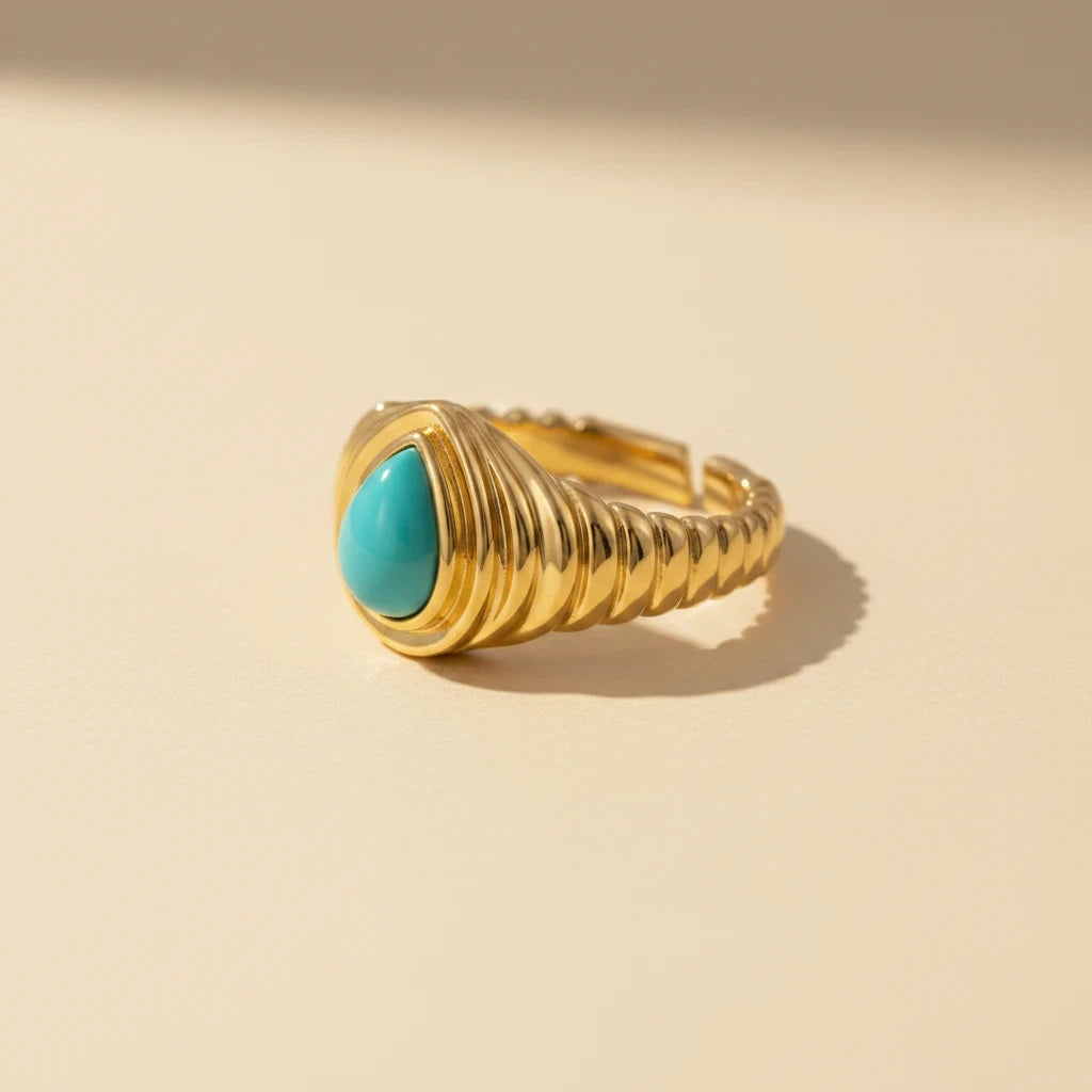 Queens Candy adjustable gold-plated sterling silver ring featuring a teardrop-shaped turquoise stone and ribbed band.