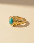 Queens Candy adjustable gold-plated sterling silver ring featuring a teardrop-shaped turquoise stone and ribbed band.