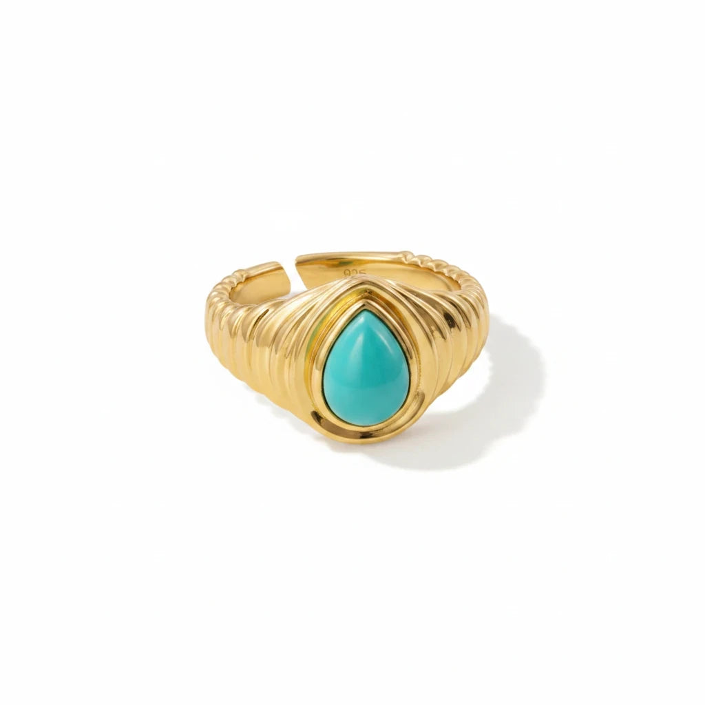 Queens Candy adjustable gold-plated sterling silver ring featuring a teardrop turquoise stone and ribbed band.