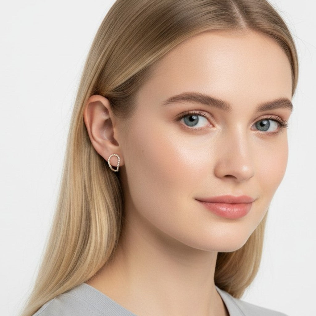 Queens Candy irregular sterling silver hugger earrings with pavé cubic zirconia worn by a blonde woman