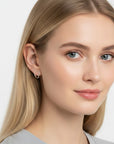 Queens Candy irregular sterling silver hugger earrings with pavé cubic zirconia worn by a blonde woman