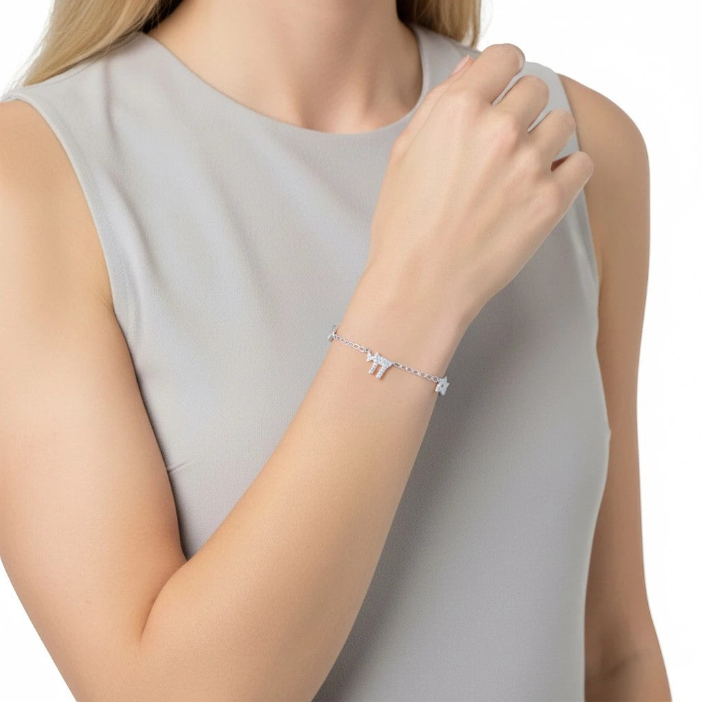 Pulsera Queens Candy de plata con dije de Hamsa y zirconias brillantes en la muñeca de una mujer