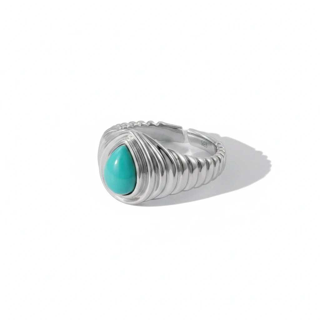 Queens Candy adjustable silver ring featuring a teardrop-shaped turquoise stone and a ribbed band design.