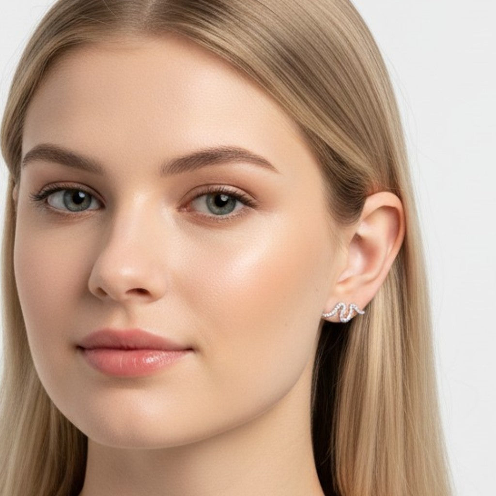 Queens Candy sterling silver stud earrings with an irregular wavy design and sparkling cubic zirconia stones on a model